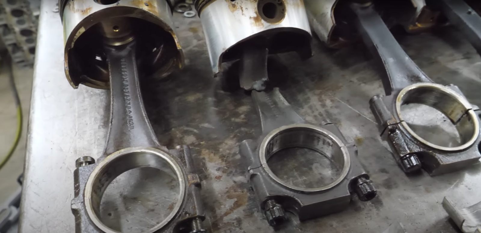 The pistons from a hydrolocked Bentley V8, including one with a snapped conrod